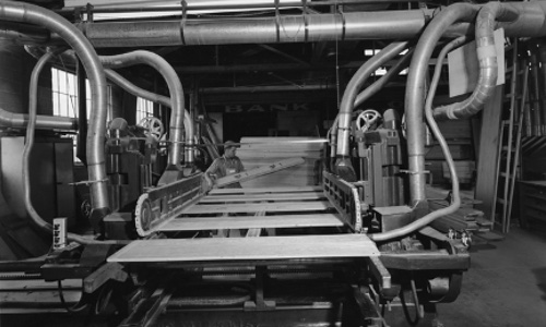 An antique image of a Fetzer Architectural Woodworking machine room.